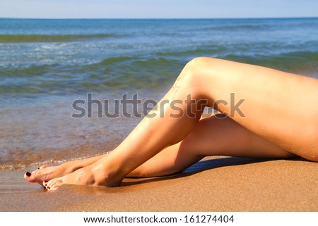 Female feet on the beach. Feet. Beach, sea, sun, relaxation