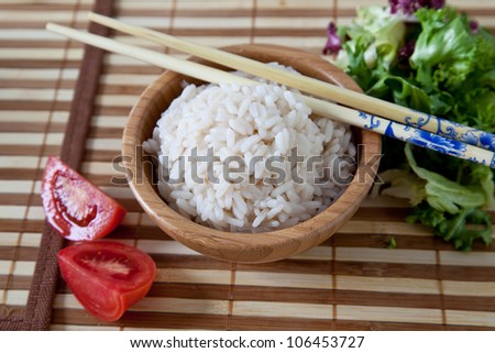 Rice in bamboo bowl with chopsticks