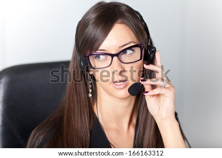 support phone operator in headset at workplace