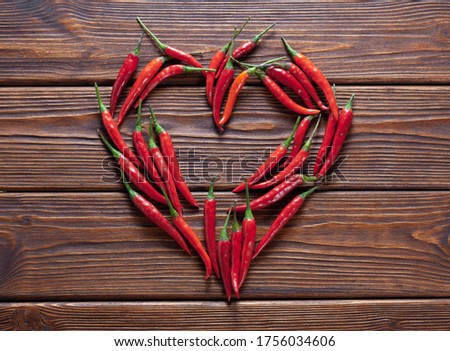background of fresh red chili pepper arranged into heart shape. Top view Foto stock © 