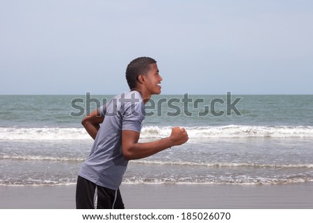 Brazilian guy running at beach