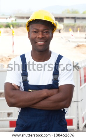 Friendly african construction worker with crossed arms