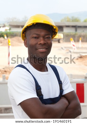 African worker at construction site looking at camera
