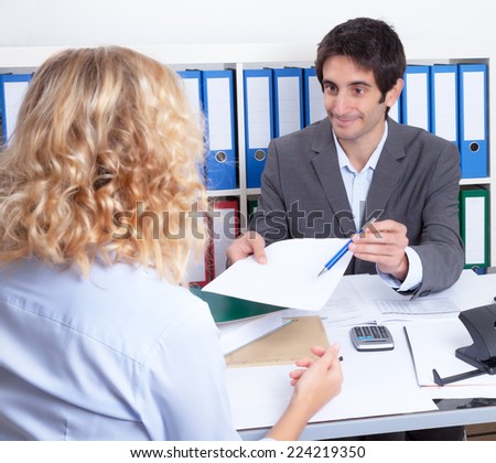 Young woman at office signing a contract