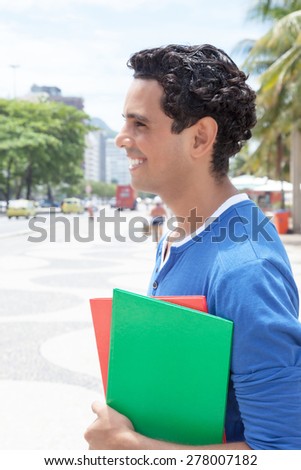 Latin student in the city looking sideways