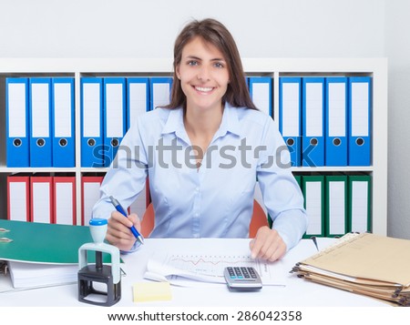 Laughing secretary with long brown hair at office