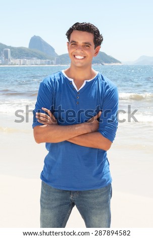 Latin guy with crossed arms at Copacabana beach at Rio de Janeiro