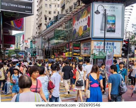 HONG KONG, CHINA - JUNE 21: People crossing the road at Causeway Bay area, Hong Kong island, on June 21, 2014. Hong Kong is considered to be one of the most densely populated areas in the world.