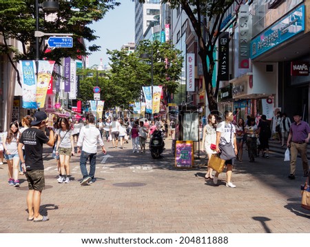 SEOUL, SOUTH KOREA - JULY 11: People are shopping in Myeongdong commercial area which Seoul Summer Sale is organised in various places, especially in Meongdong, during the whole month of July 2014.
