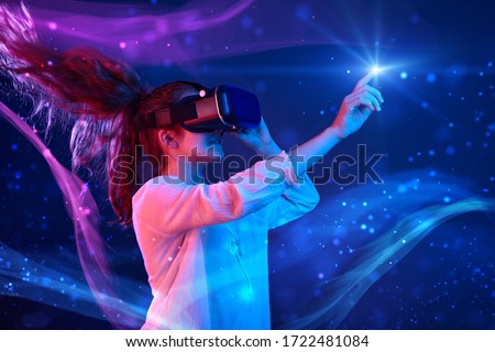 Woman with glasses of virtual reality. Future technology concept. Colorful neon lights. 商業照片 © 