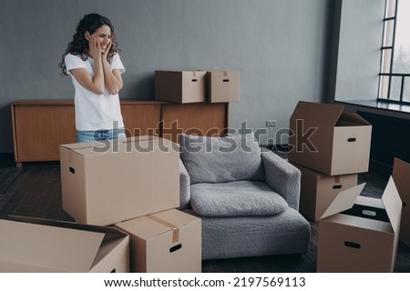 New first home, relocation. Happy hispanic female homeowner contemplating empty room, standing among cardboard boxes on moving day. Cute smiling woman renter feels happiness with removal. Foto stock © 