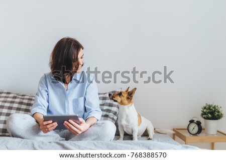 Similar – Image, Stock Photo Woman with dog sits cross-legged in dry late summer meadow