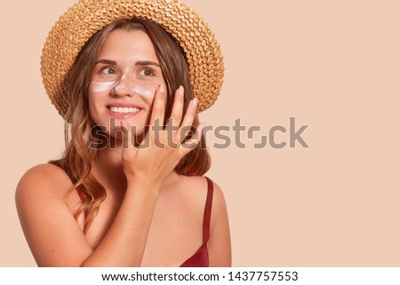 Similar – Image, Stock Photo Photo of delighted curly woman keeps both hands on waist, smiles gently, has slim figure, wears white t shirt and black jeans, being in good mood, stands self assured against white background