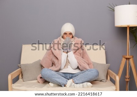 Similar – Image, Stock Photo Woman sitting on frozen river and tying the shoelaces