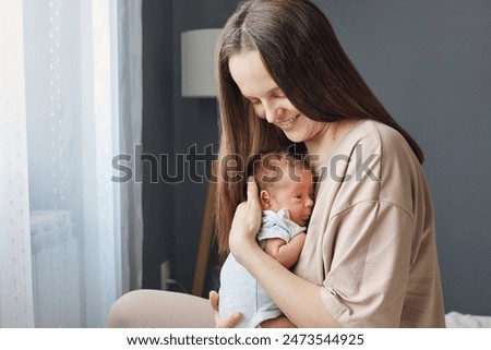 Similar – Image, Stock Photo Mother breastfeeding and hugging her baby boy outdoors