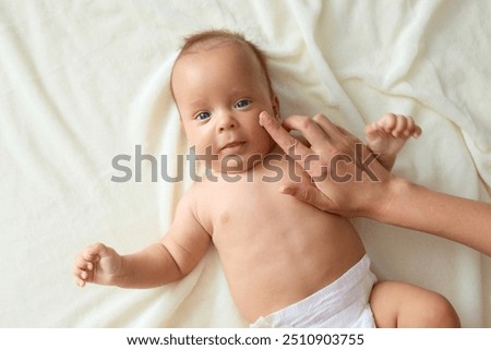 Similar – Image, Stock Photo Anonymous delicate mother sitting on floor with newborn at home