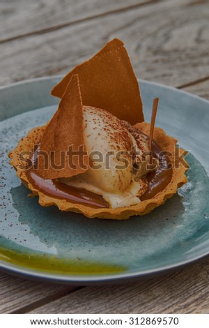 Caramel Sauce  and Baileys icecream served on a shell biscuit
