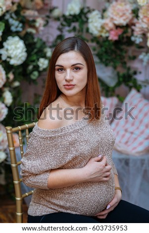 A Very Beautiful Young Pregnant Girl With Red Lips In A Dress Gently Holds Her Belly A Very Beautiful Young Pregnant Girl With Red Lips In A Dress Gently Holds Her Belly