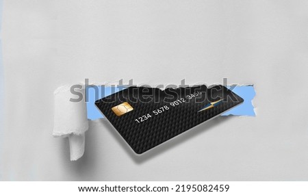 A generic mock credit card is seen bursting through torn paper providing plenty of text area or copy space in this 3-d illustration about finance. Stock fotó © 