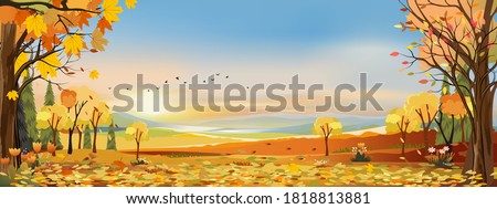 Autumn landscapes of Countryside with sunset and blue and pink sky,Panoramic of mid autumn with farm field, mountains, leaves falling from trees in orange foliage. Wonderland in fall season