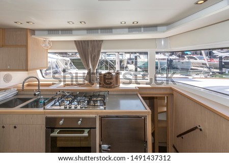 Interior of the luxury sailing catamaran - salon and cabin. Large and bright lounge with galley. Spacious cabin with high double bed and bright interior. Finishing with light wood VIP yachts ストックフォト © 