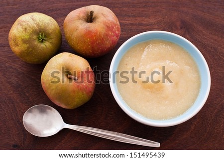 apples and apple sauce on wooden background