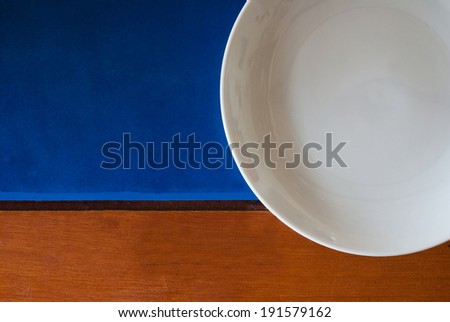 empty plate on blue filed background