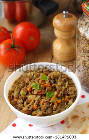 Vegan dinner - green lentils with vegetables on rustic table