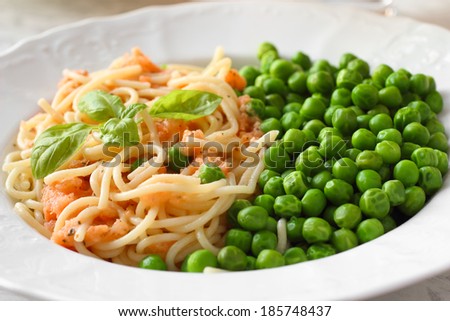 Vegan meal. Pasta with tomato sauce and green peas