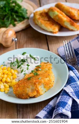 Cooked rice, corn and fried cabbage with bread crumbs - vegan version of schnitzel