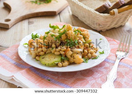 Spicy cooked soy beans with cauliflower and marrow squash on a plate. Healthy vegan food