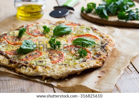 Homemade veggie pizza with cheese, basil, tomatoes and bell pepper