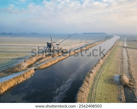 Similar – Image, Stock Photo Windmill at edge of breakwater