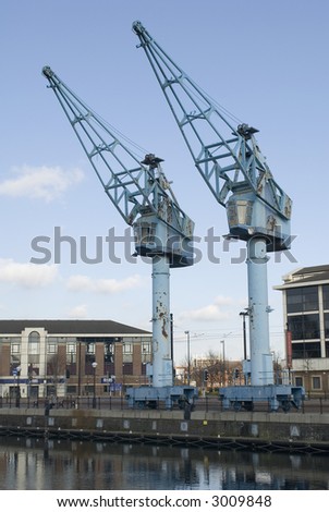 Salford quays, manchester, two original cranes on the side of the regenerated dockside showing the original heritage of lowrys salford
