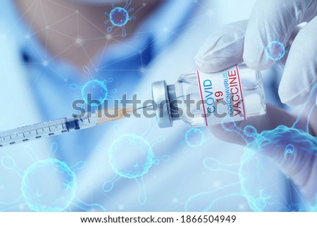 Vaccination against the new Coronavirus SARS-CoV-2. Doctor holding Corona virus vaccine and syringe using for prevent COVID-19 infection.