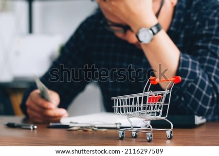 Man holding his forehead while having headache due to higher food prices from inflation.Rising food and grocery store prices and expensive daily consumer goods concept. The problem of inflation Stock foto © 