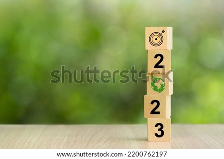 Happy New Year 2023 on the wood cube block on green background. business and environmental sustainability target. Start new year 2023 with a goal plan, action plan, strategy, new year business vision. 商業照片 © 