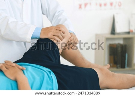 Similar – Image, Stock Photo Physiotherapist stretching leg of patient in medical room