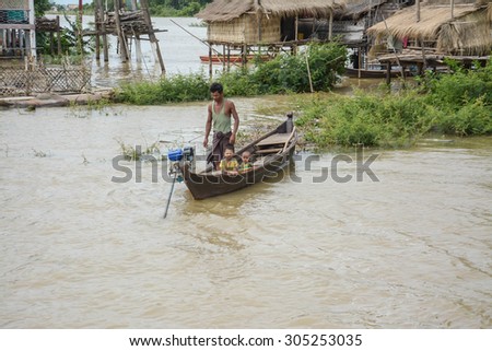 MANDALAY, MYANMAR - AUGUST 01 :  People on boat at heavy flooding in Mandalay on August 01. 2015 in Mandalay, Myanmar.