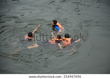KANCHANABURI PROVINCE, THAILAND - SEPTEMBER 13: people swimming  in river Kwai. Taken at Sai Yok Yai waterfall. Kanchanaburi of Thailand. on September 13, 2015.