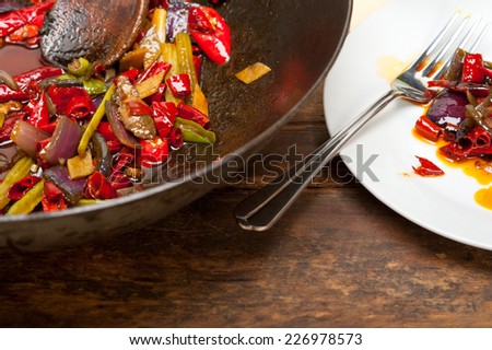 fried chili pepper and vegetable on a iron wok pan