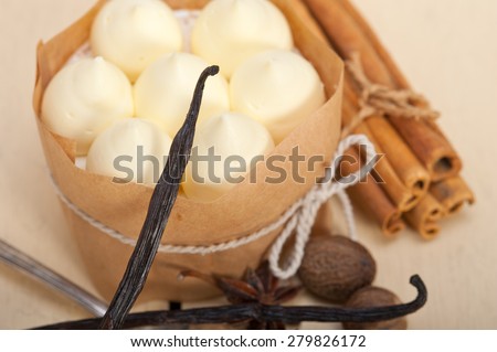 fresh vanilla and spice cream cake dessert over a rustic white wood table