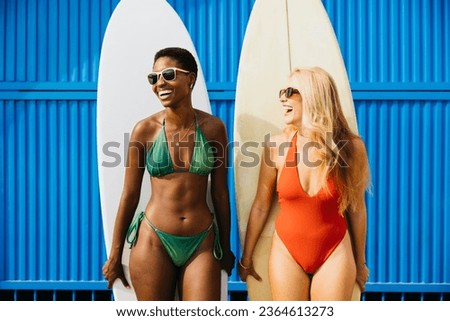 Similar – Image, Stock Photo Surfer friends at the beach with surfboards taking selfie with mobile phone