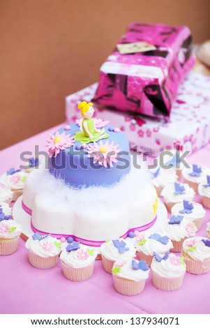 Homemade decorated birthday cake and cupcakes