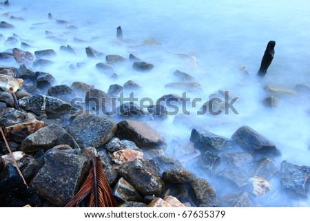 Smooth moving stream on the rocks (misty water)