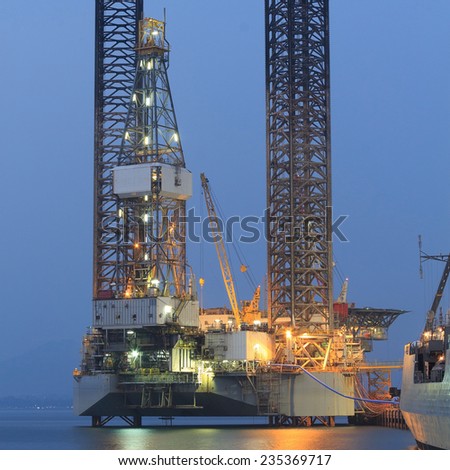 Jack up oil drilling rig in the shipyard in the evening
