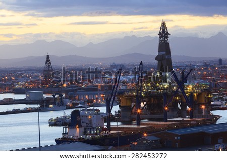 CAPE TOWN, SOUTH AFRICA - OCTOBER, 17: Semi Submersible drilling rig parked in the middle of the shipyard in downtown of Cape Town to get maintenance on October 17, 2013 in Cape Town, South Africa.