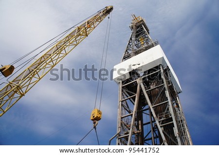 Derick of jack up drilling rig with the yellow rig crane