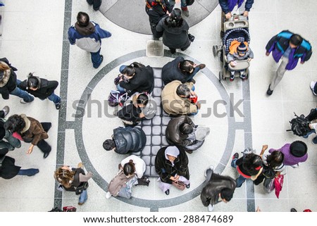 Toronto, Canada - 26 December, 2007 - the view from above of a group of people sitting in an Eaton Centre corridor, in a boxing day.