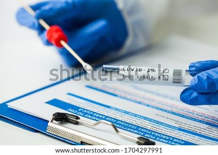 Medical NHS worker holding Coronavirus COVID-19 NP OP LFT swab sample test kit,nasal collection equipment submitting form,reverse transcription RT-PCR DNA molecular nucleic acid diagnostic procedure  Photo stock © 